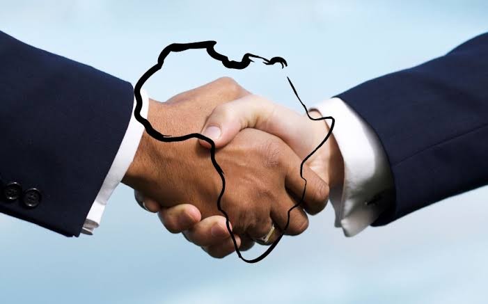 Professional handshake with the map of Africa